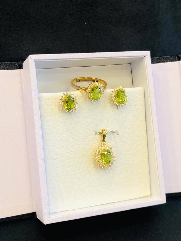 Gold peridot ring, earrings and pendant set