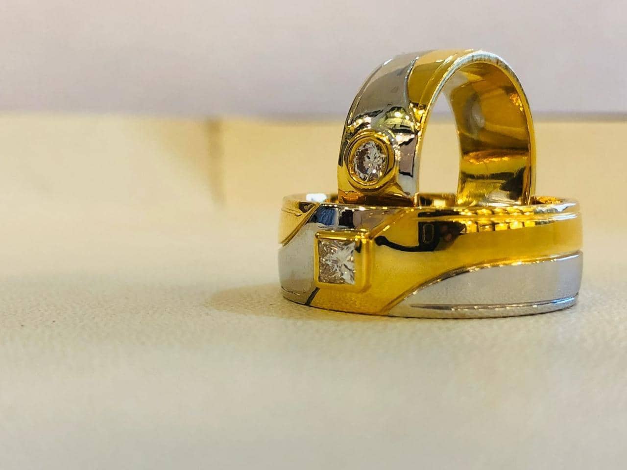 Two-tone gold couple rings set with solitaire stones