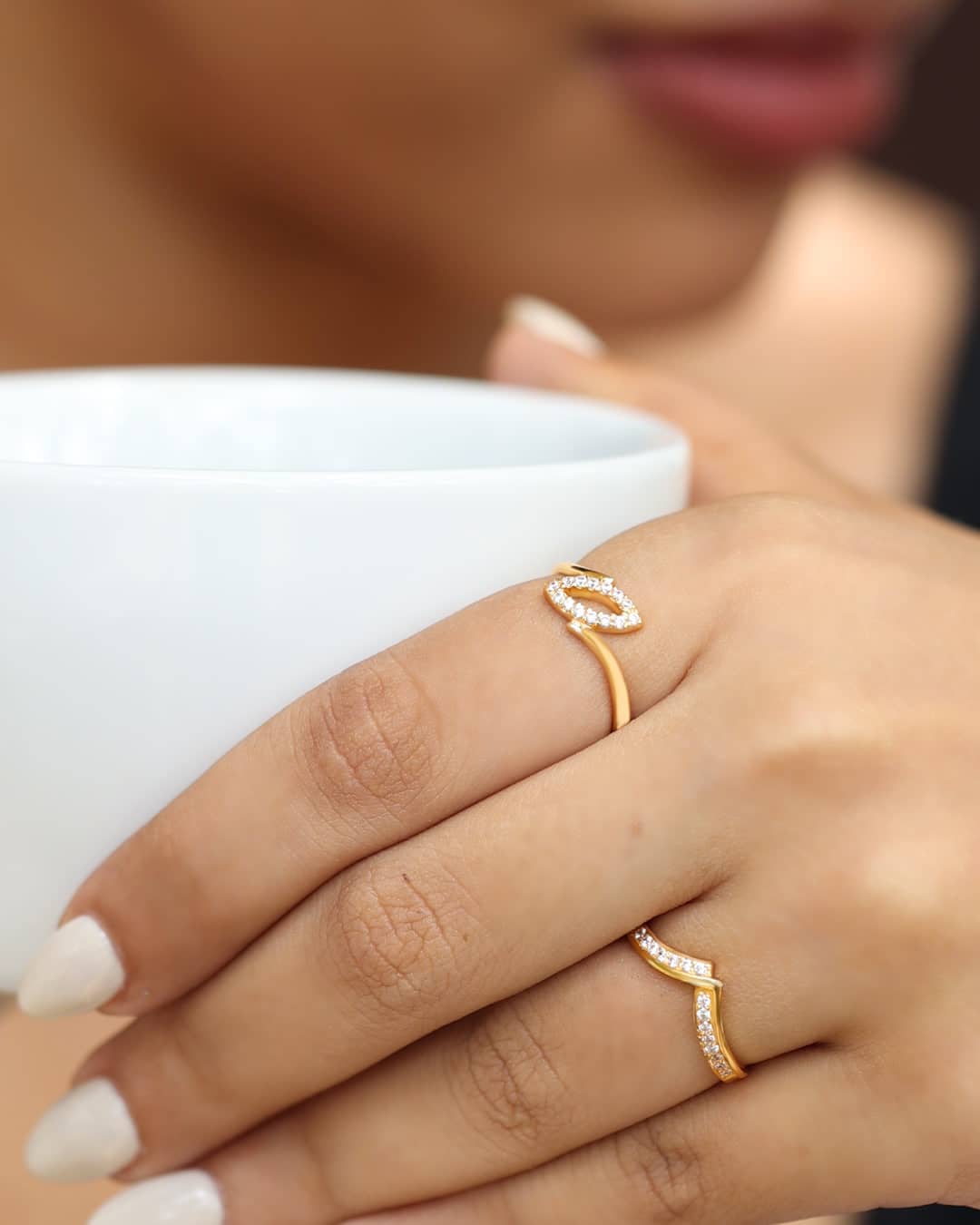 Two delicate gold rings set with sparkling stones