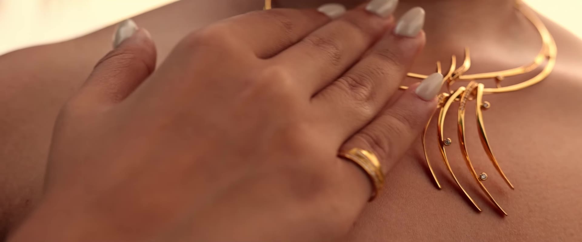 Sculptural gold necklace with matching gold ring
